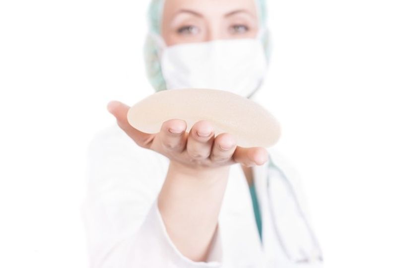 Nurse holding a breast implant
